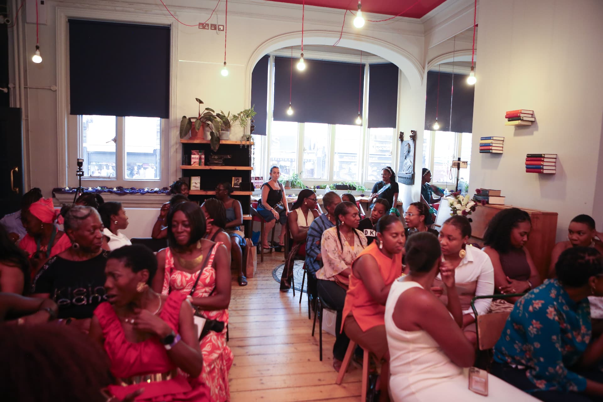 Wide view of the audience seated across the room